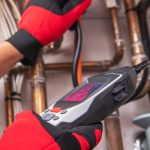 Professional gas leak detection tool in use by technician, highlighting plumbing maintenance and safety measures.